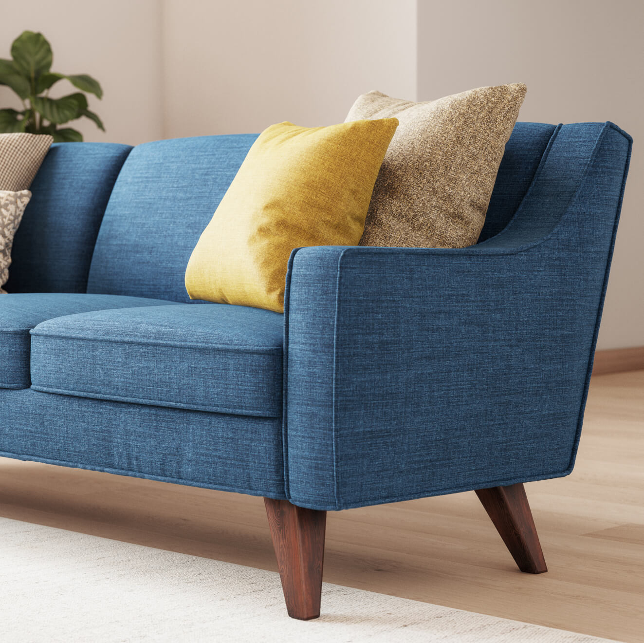 Zavis Sofa in Deluxe Petrol fabric with Lulu Throw Pillow in Kala fabric and Judge Throw Pillow in Phulara fabric