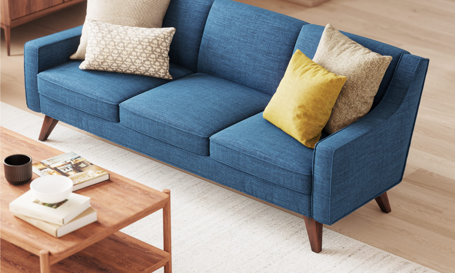 Zavis Sofa in Deluxe Petrol fabric with Iris Coffee Table and Lulu + Judge Throw Pillows