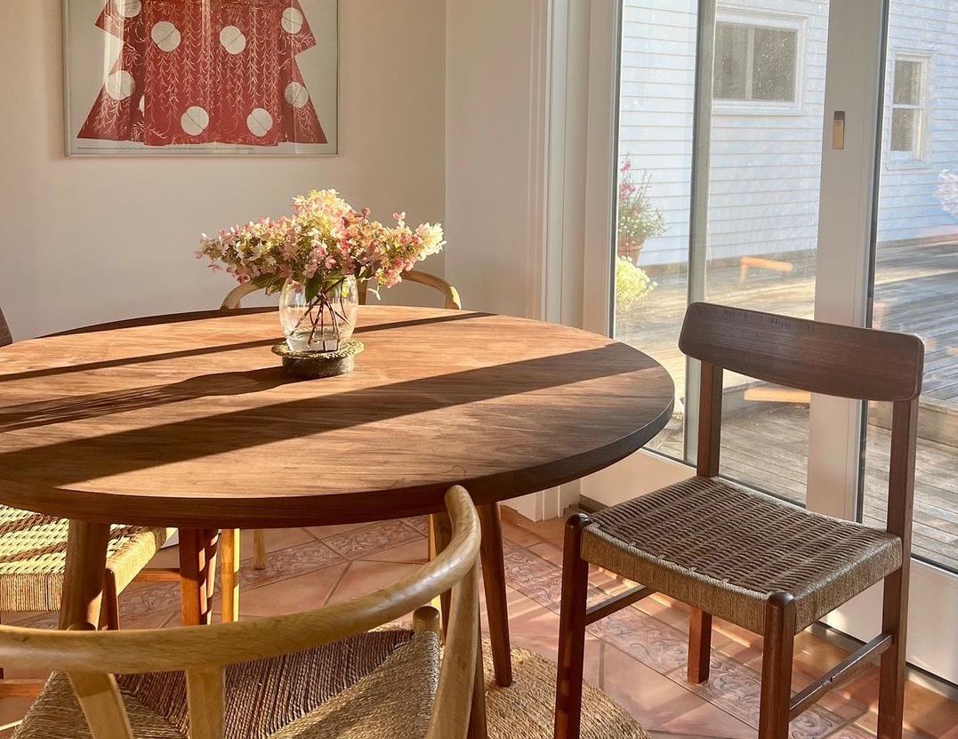 G: Voya Round Dining Table in Walnut. Image courtesy of @corahilts