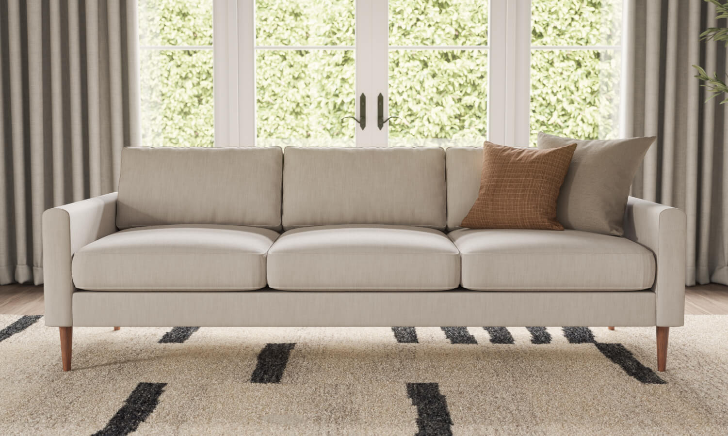 IRL: Lala sofa in beige fabric with orange pillow