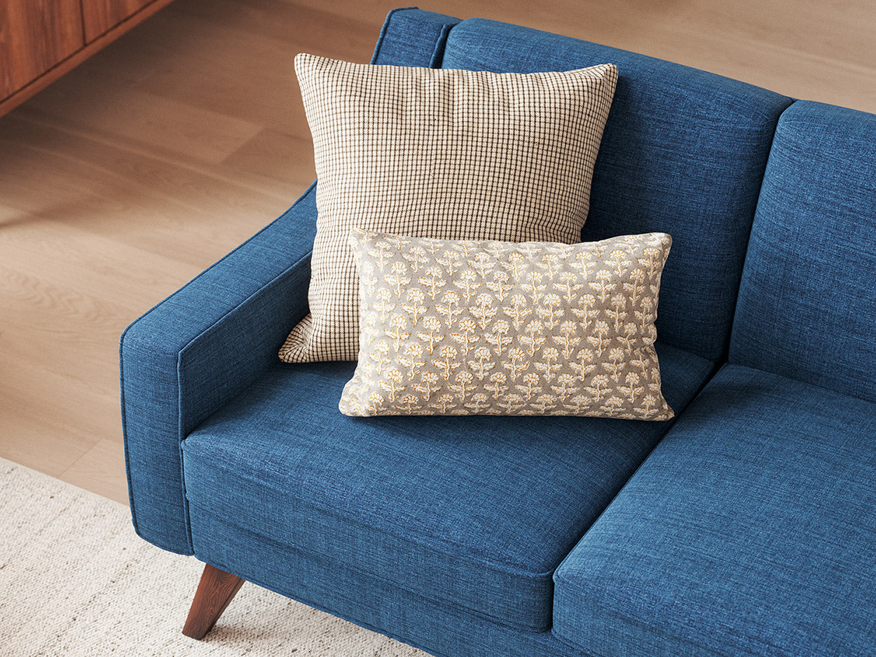Judge Throw Pillow in Phulara Grey Mustard Fabric with Lulu Throw Pillow in Kala fabric on the Zavis Sofa in Melton Raven fabric