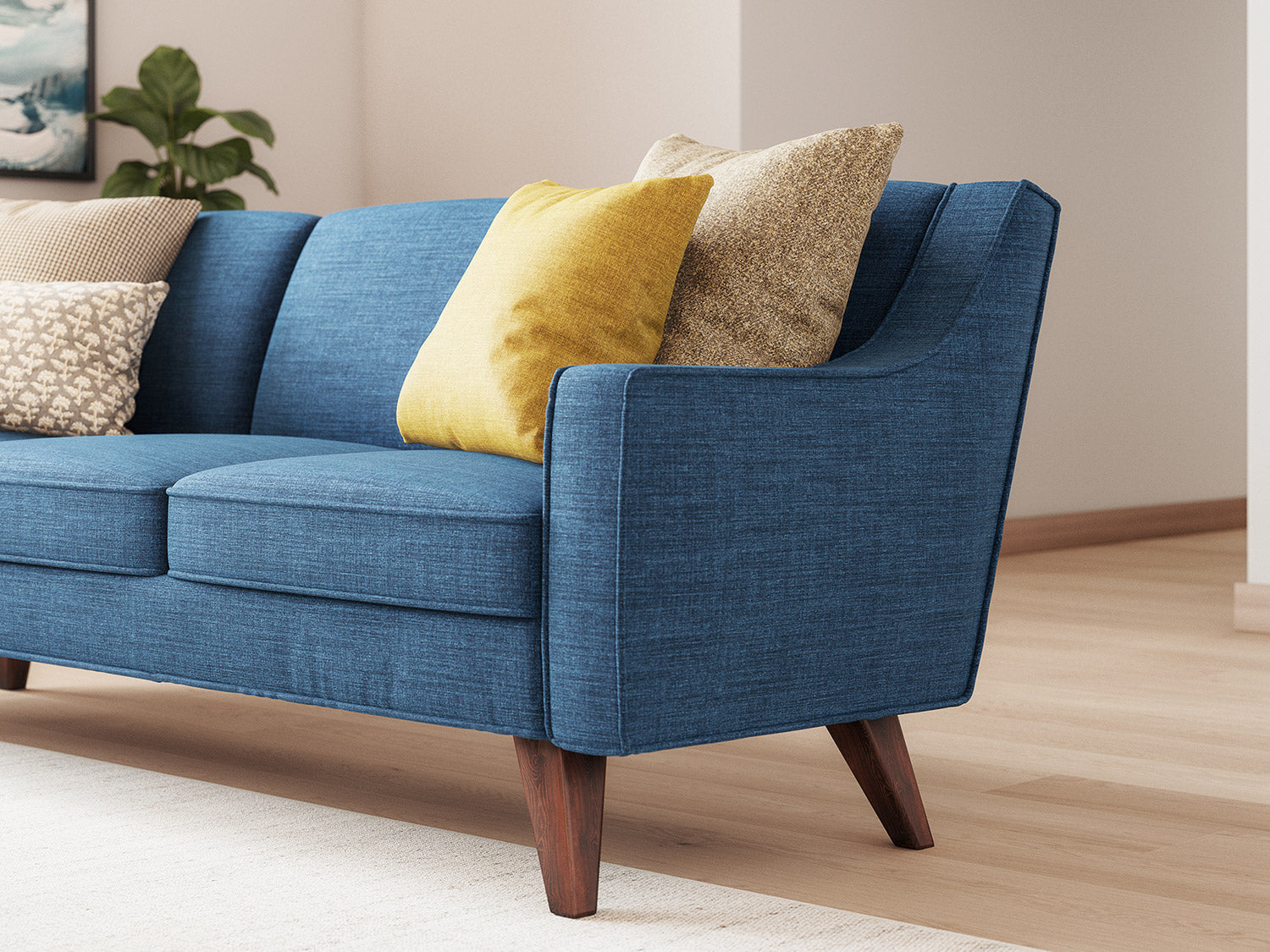 IRL: Lulu 16" Throw Pillow in Deluxe Amber fabric nested in front of the Lulu 18" Throw Pillow in Melton Mushroom fabric on the the Zavis Sofa in Melton Raven fabric
