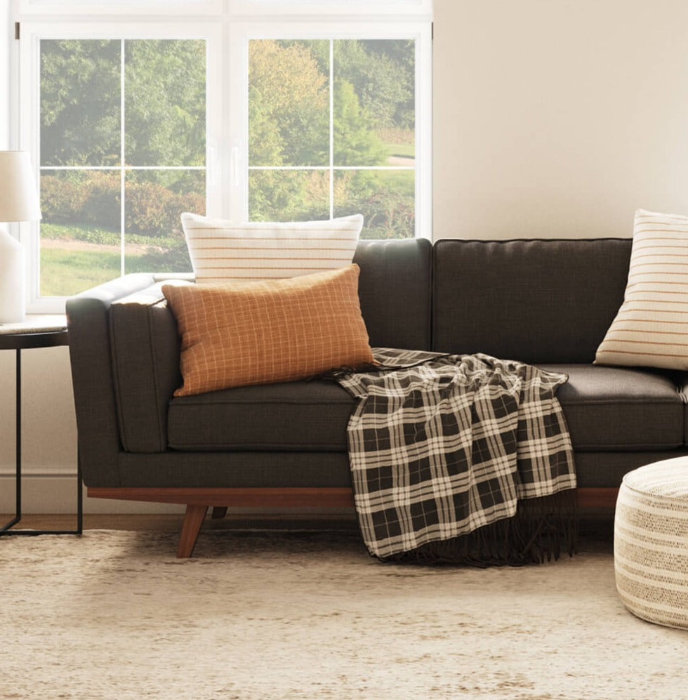 Shown in Deluxe Elephant Fabric with Lulu PIllows in Sirsi and Bahara, Ridge Chair in Fargo Leather, and Norah Pouf Dhani Fabric