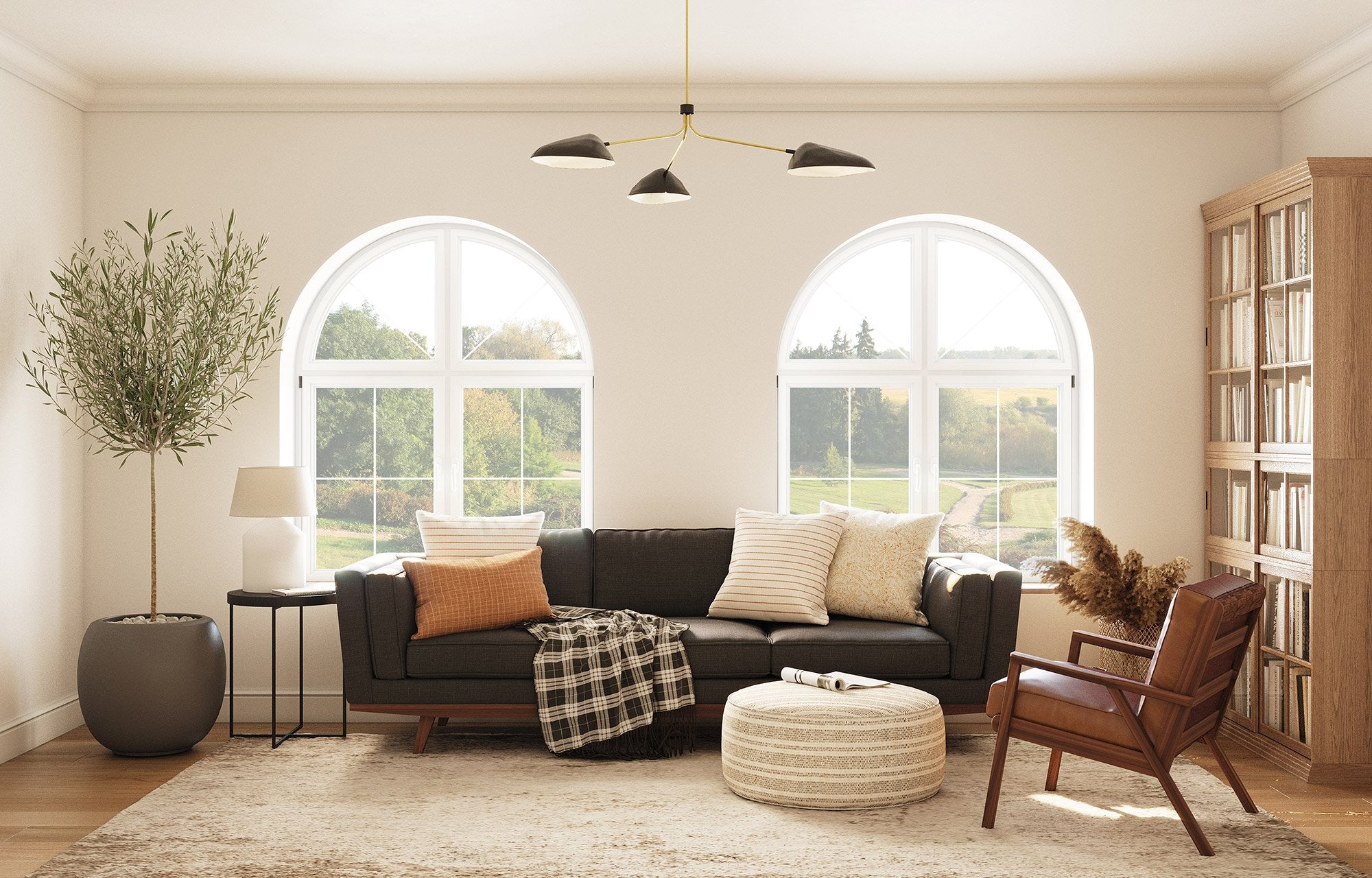 Kirnik Sofa in Texture Oyster. Lulu PIllows in Sirsi and Bahara Fabrics, Ridge Chair in Fargo Leather, Norah Pouf in Dhani Fabric